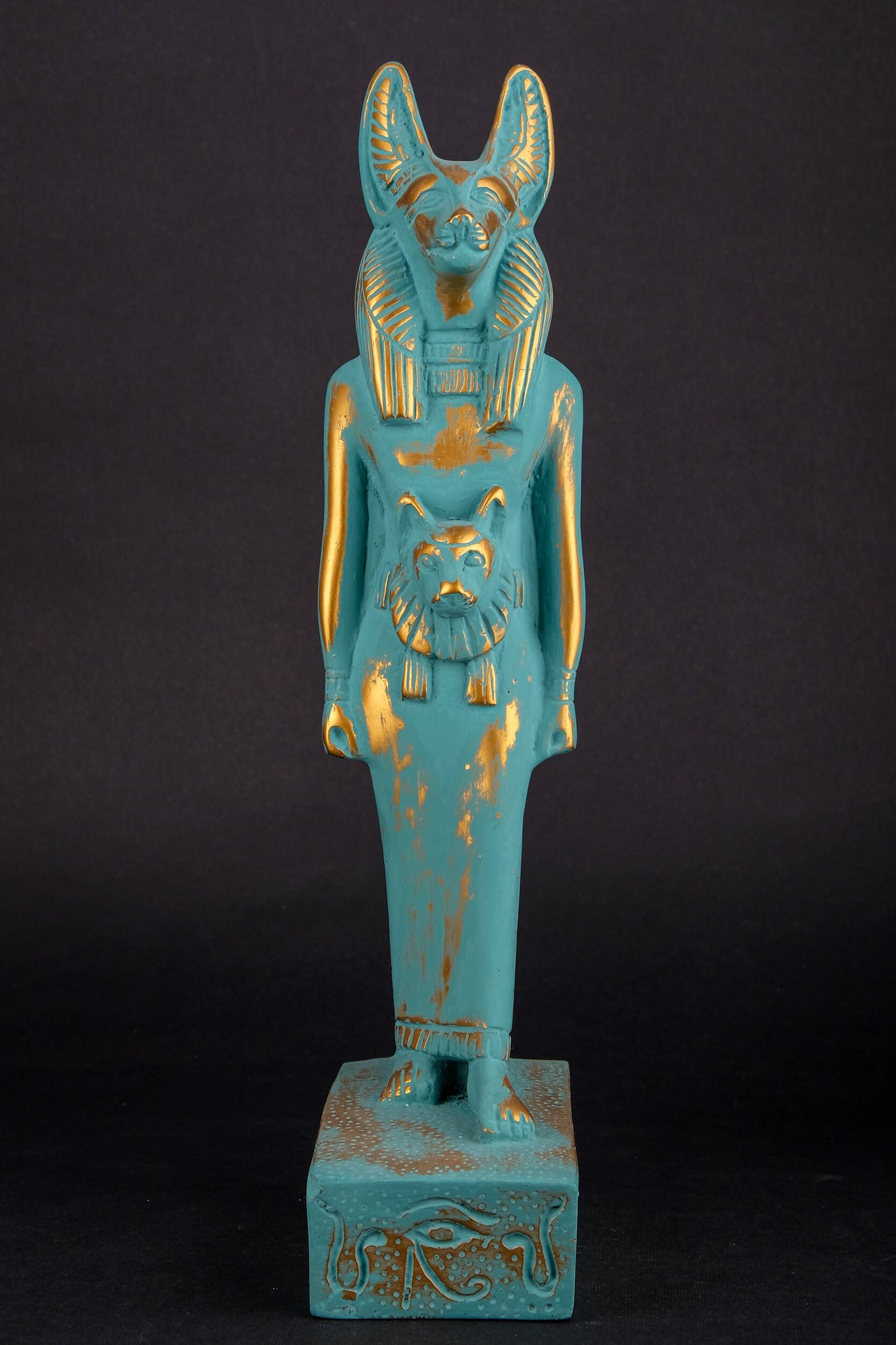 Ancient Egyptian statue of Anubis Jackal symbol of afterlife and mummification, with front a head of Sekhmet green goldish color