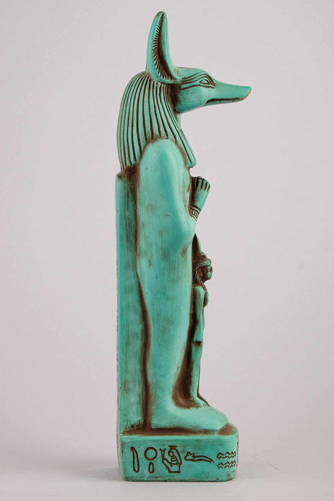 Egyptian statue of Anubis green Jackal God of afterlife and mummification standing with jackal head and human body with goddess Isis