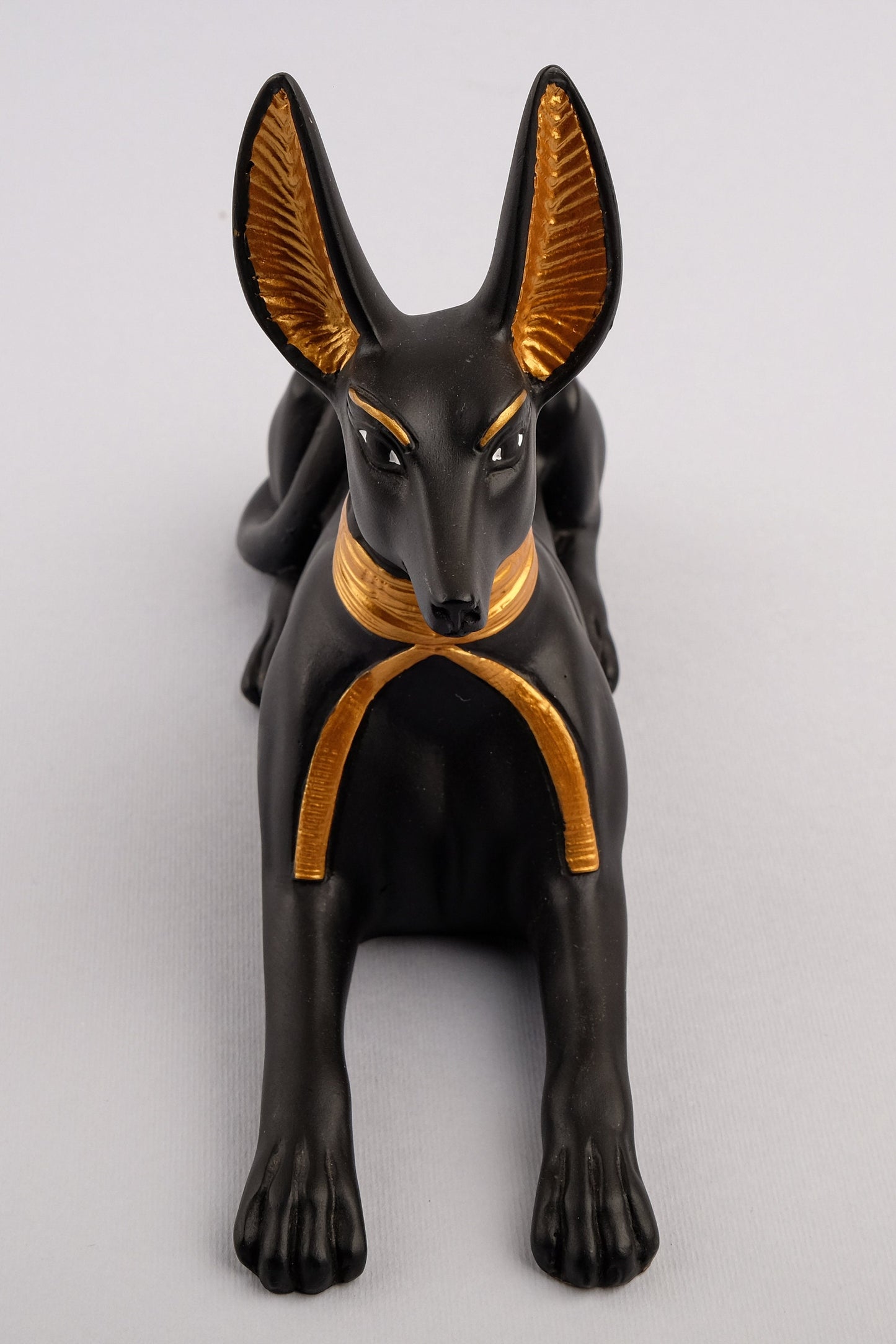 A unique ancient Egyptian statue of Anubis Jackal God of afterlife and mummification, stone black and gold painted made in Egypt