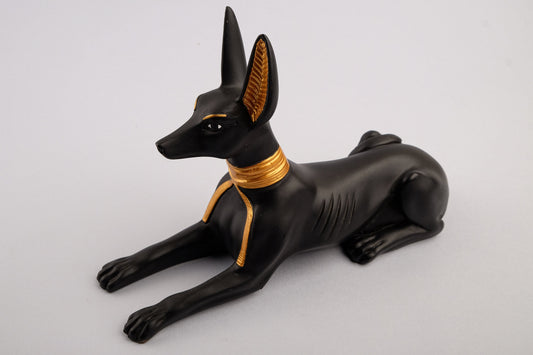 A unique ancient Egyptian statue of Anubis Jackal God of afterlife and mummification, stone black and gold painted made in Egypt