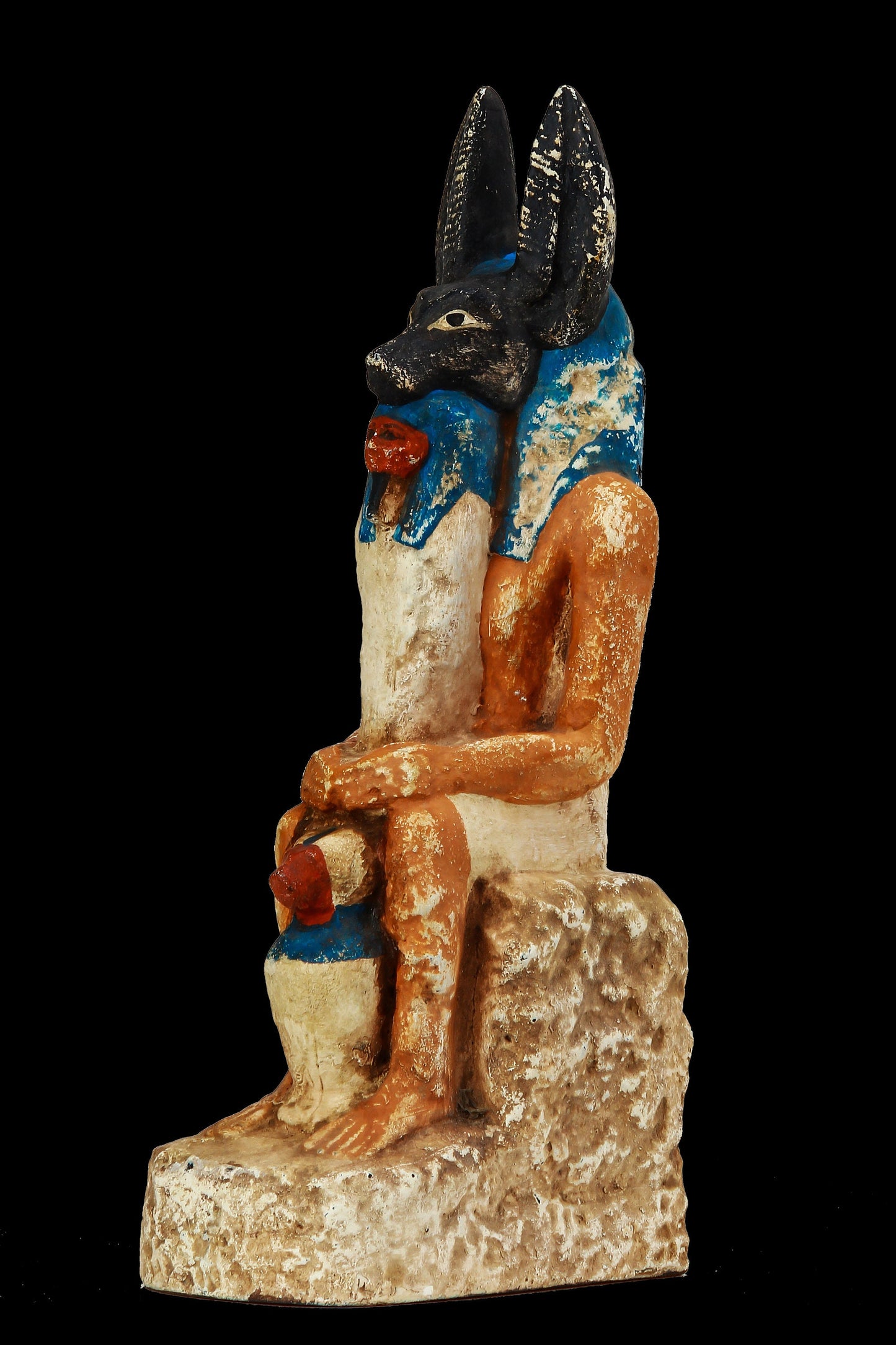 Seated Anubis holding a mummy form with a Hapi (Son of Horus) resting between his legs heavy stone handcrafted made in Egypt