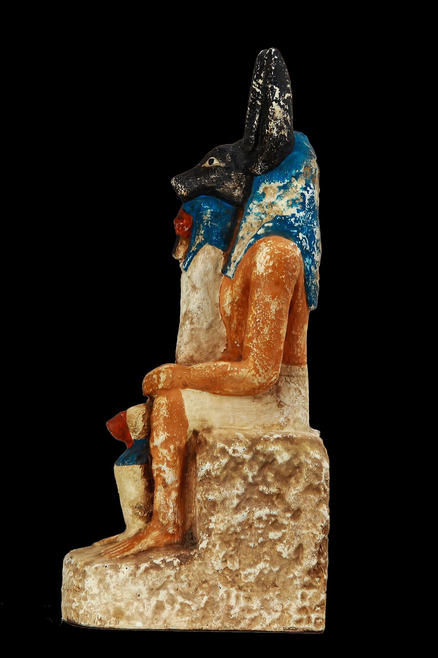 Seated Anubis holding a mummy form with a Hapi (Son of Horus) resting between his legs heavy stone handcrafted made in Egypt