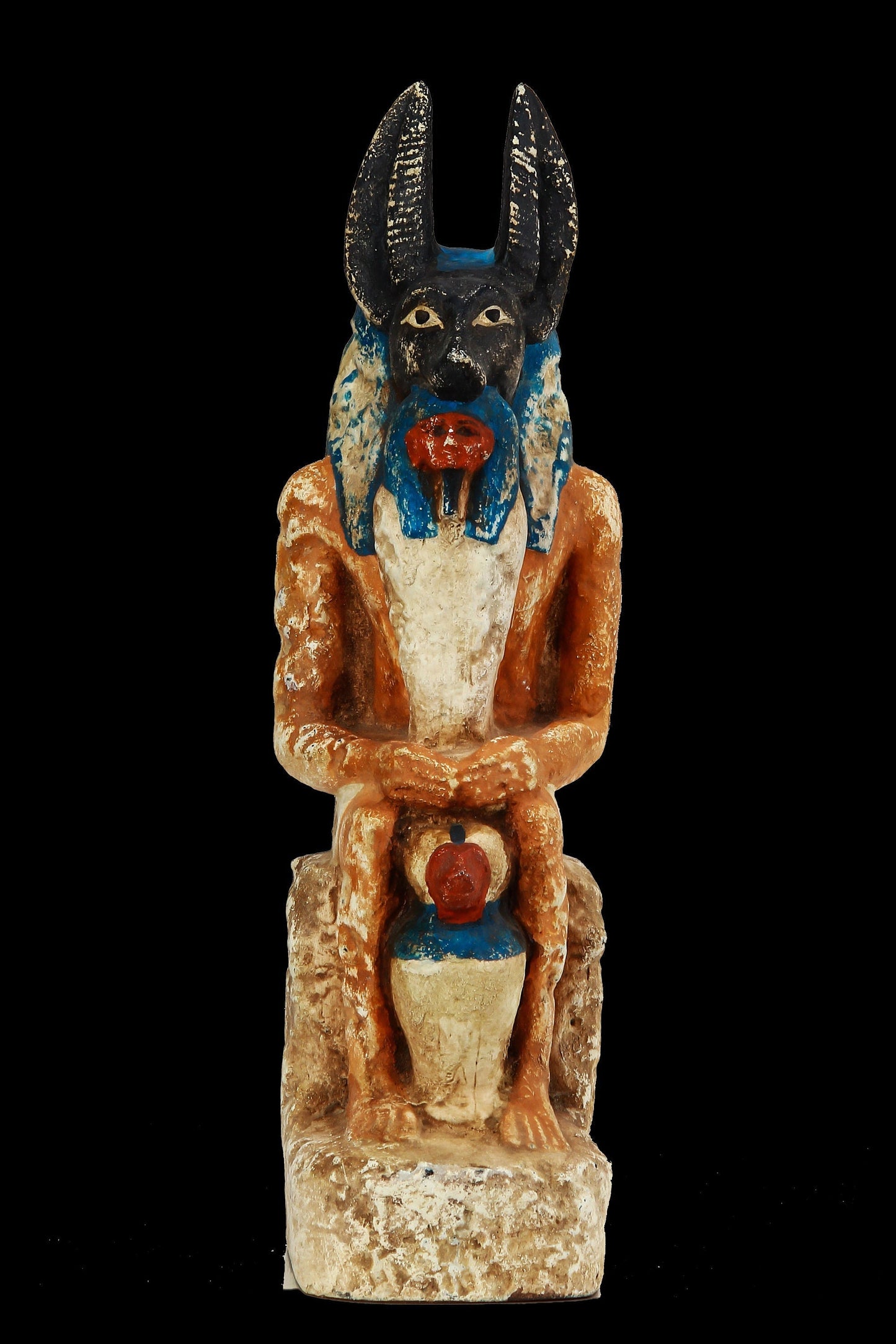 Seated Anubis holding a mummy form with a Hapi (Son of Horus) resting between his legs heavy stone handcrafted made in Egypt