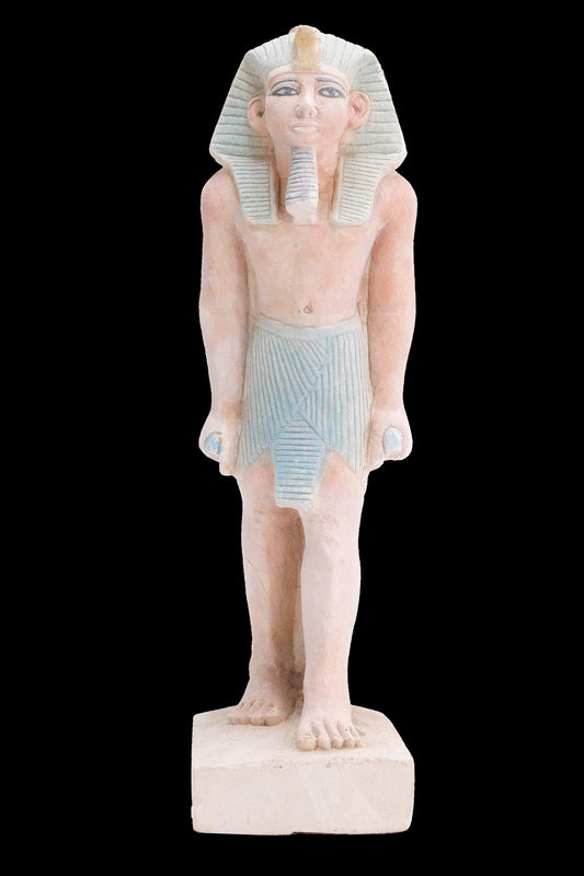 Ancient Egyptian statue of Pharaoh king Ramses II standing hand made from lime stone made in Egypt