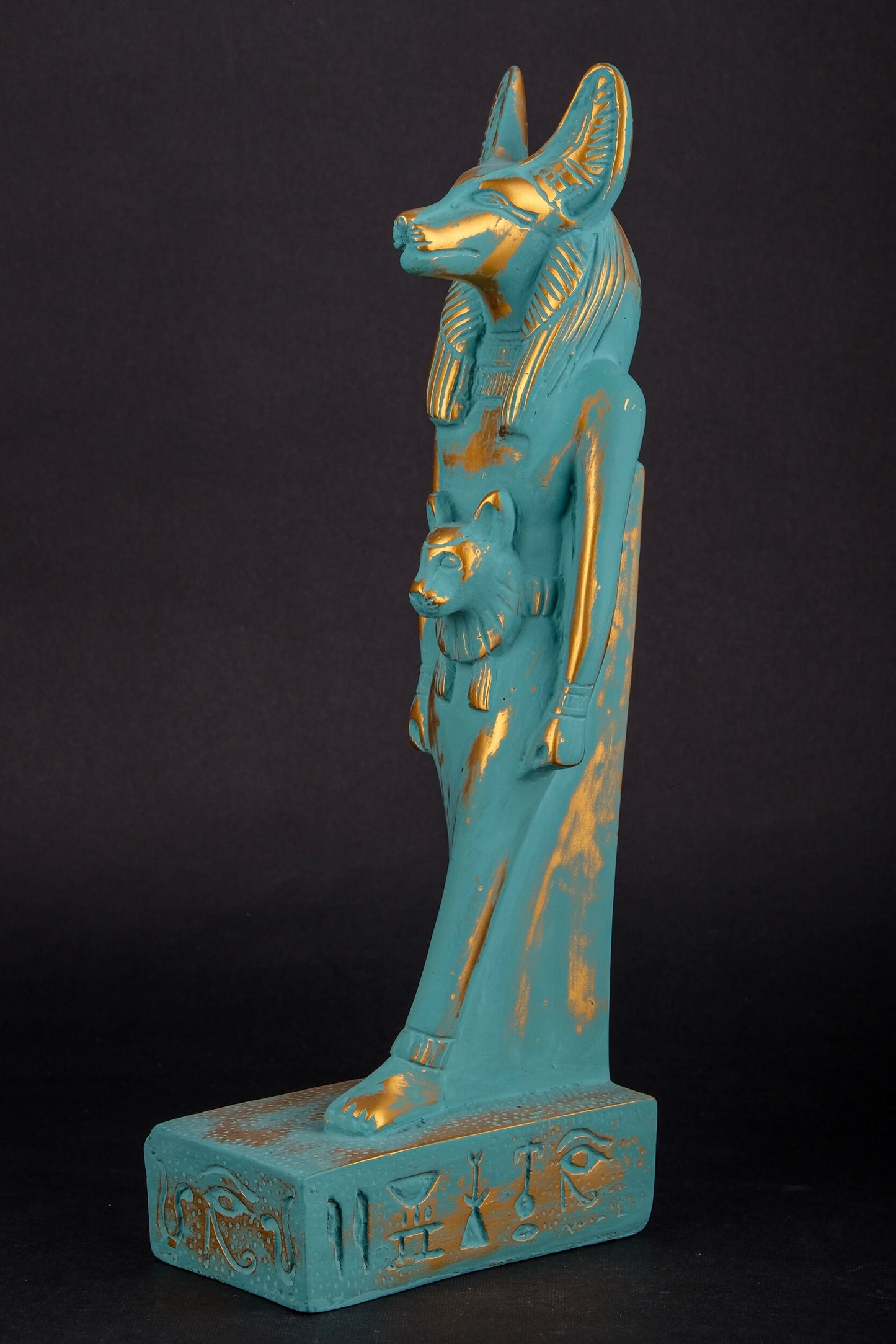 Ancient Egyptian statue of Anubis Jackal symbol of afterlife and mummification, with front a head of Sekhmet  green goldish color