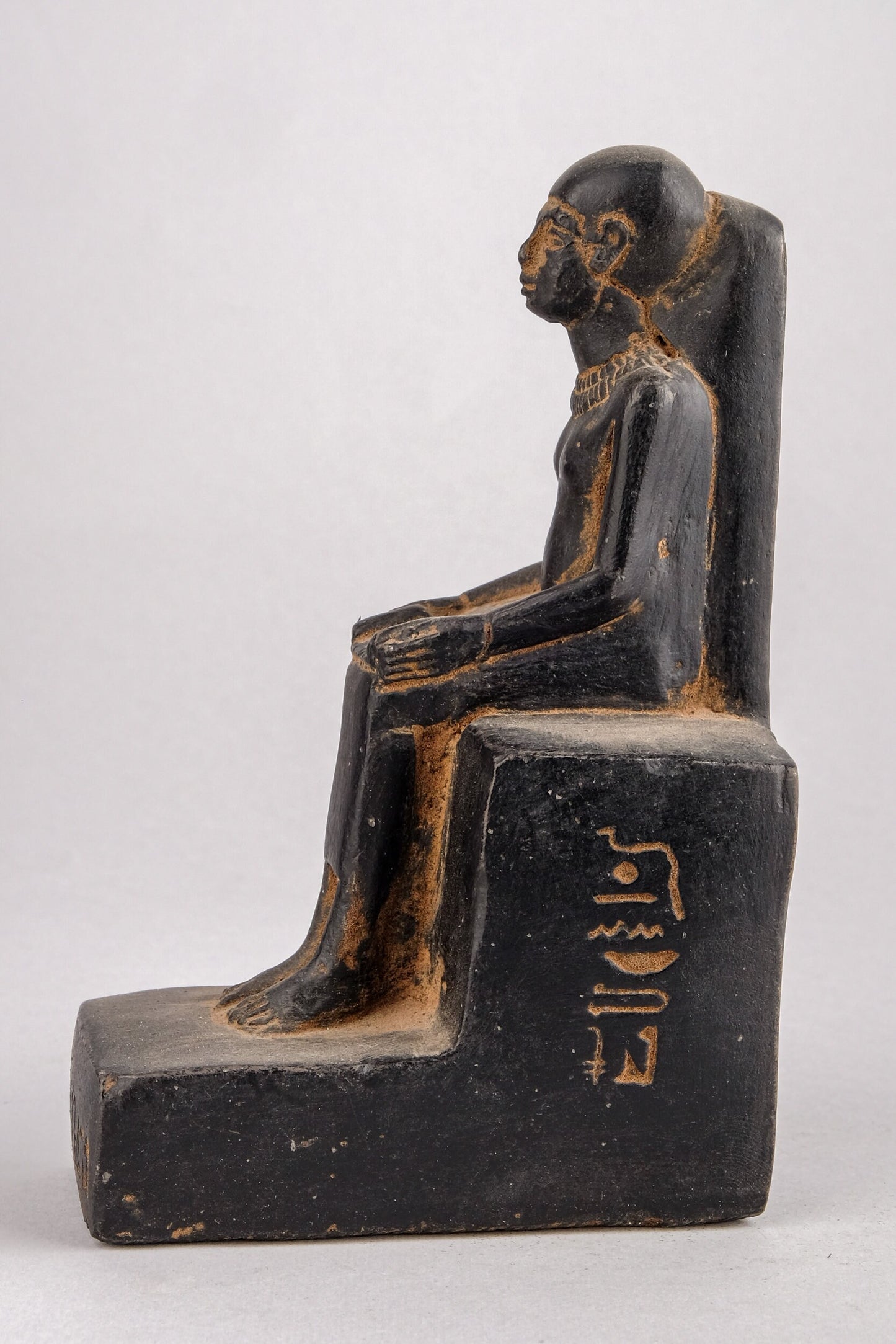 Statue of Egyptian Art seated statue of Imhotep holding an open papyrus scroll heavy black stone made in Egypt.