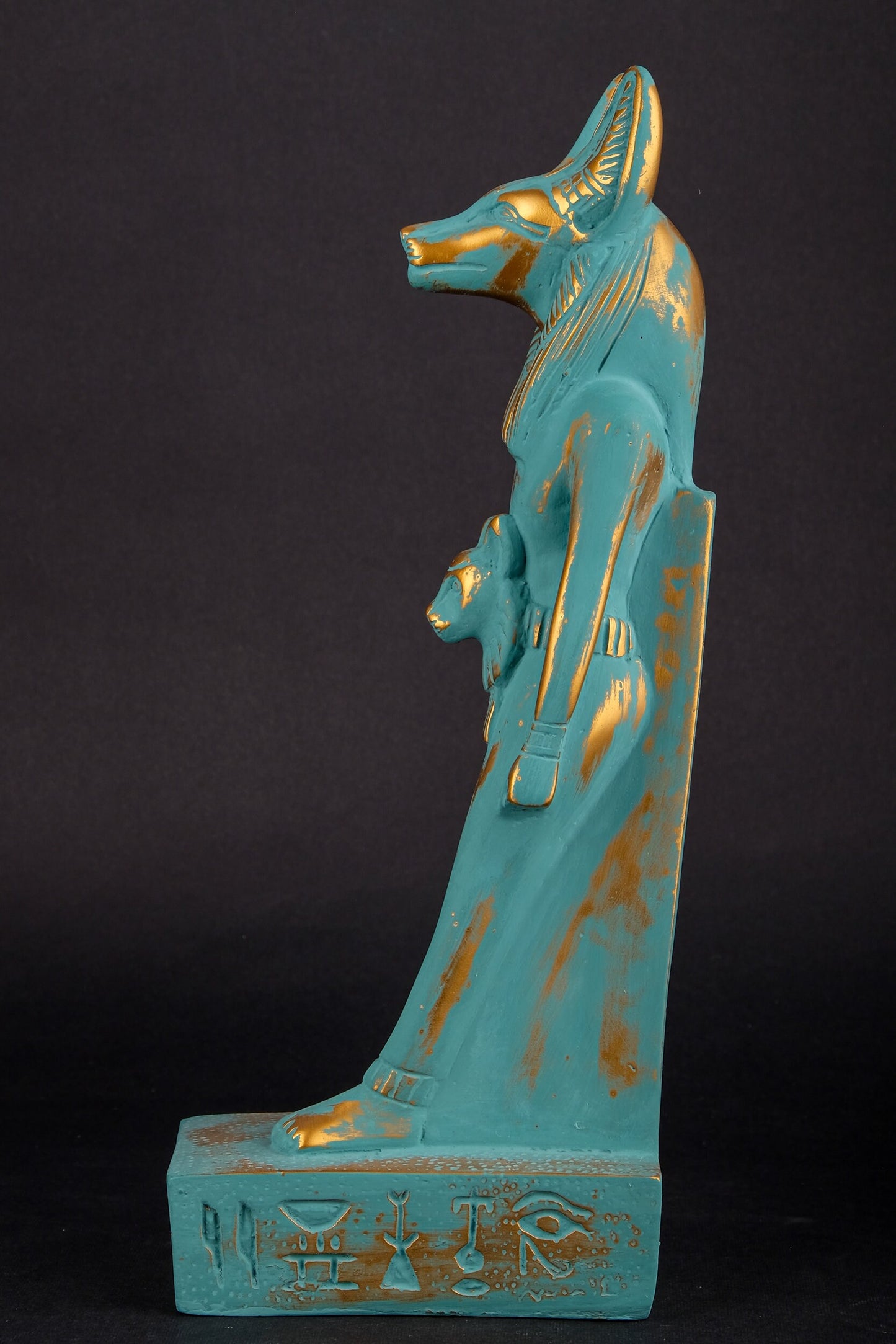 Ancient Egyptian statue of Anubis Jackal symbol of afterlife and mummification, with front a head of Sekhmet  green goldish color