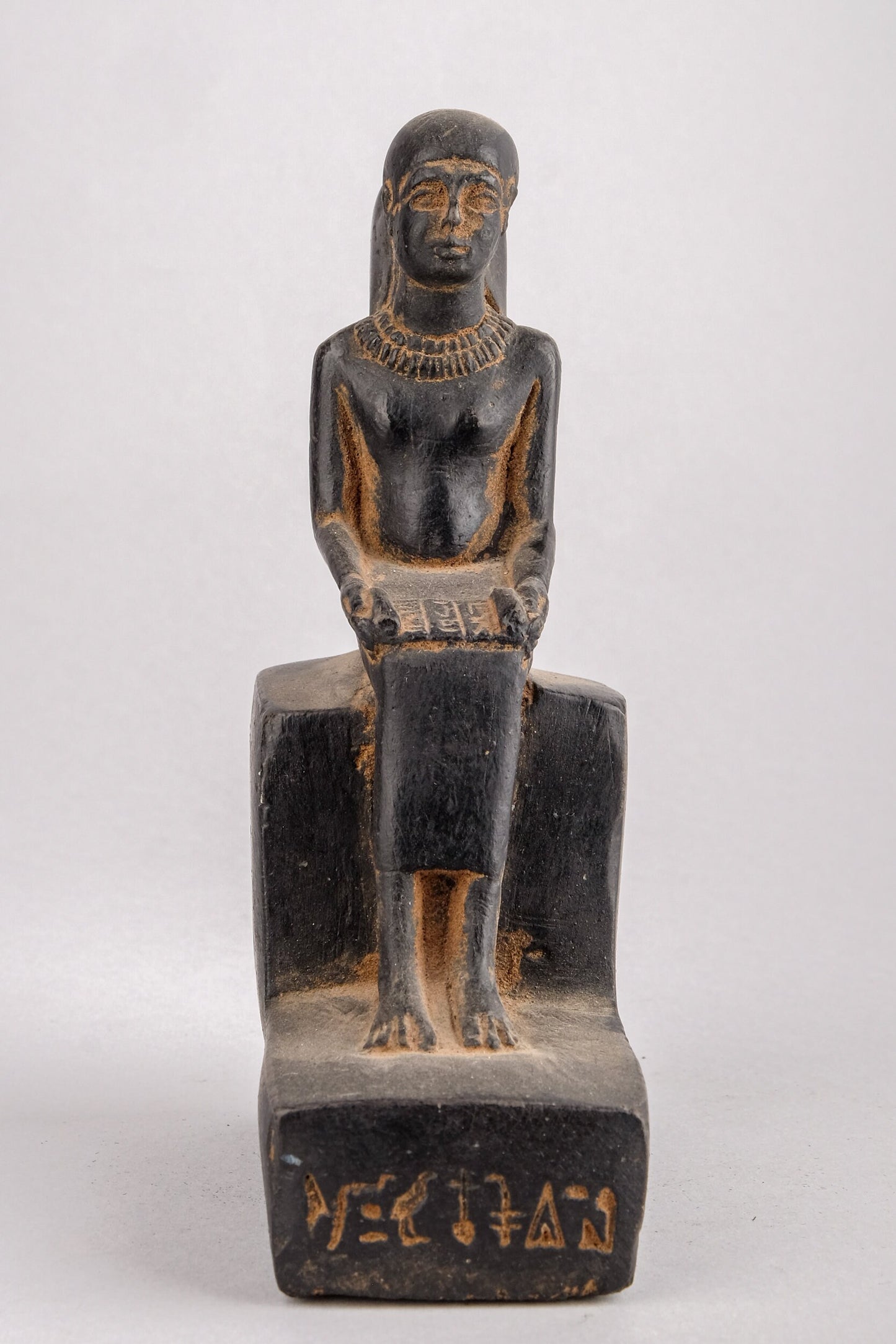 Statue of Egyptian Art seated statue of Imhotep holding an open papyrus scroll heavy black stone made in Egypt.