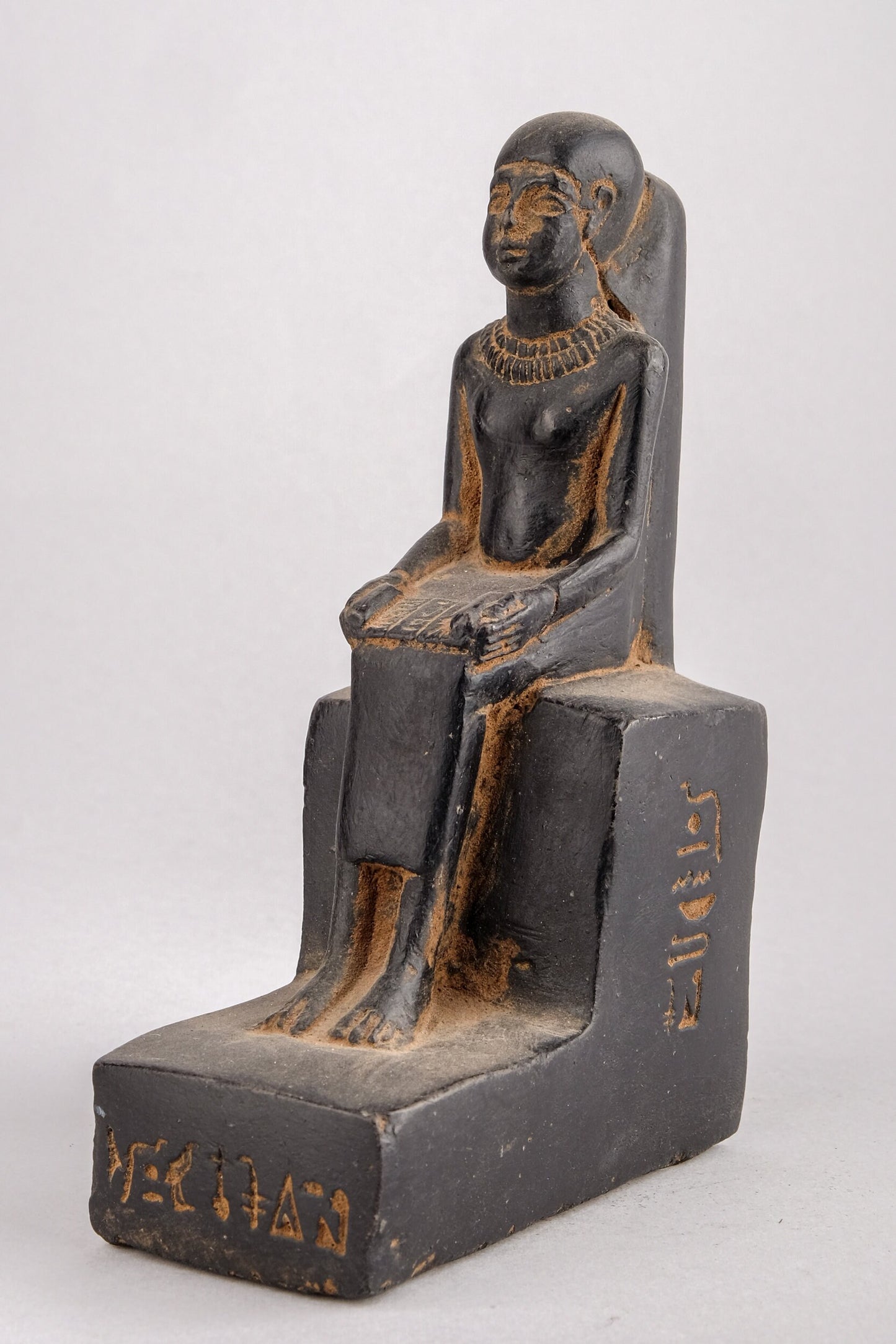 Statue of Egyptian Art seated statue of Imhotep holding an open papyrus scroll heavy black stone made in Egypt.