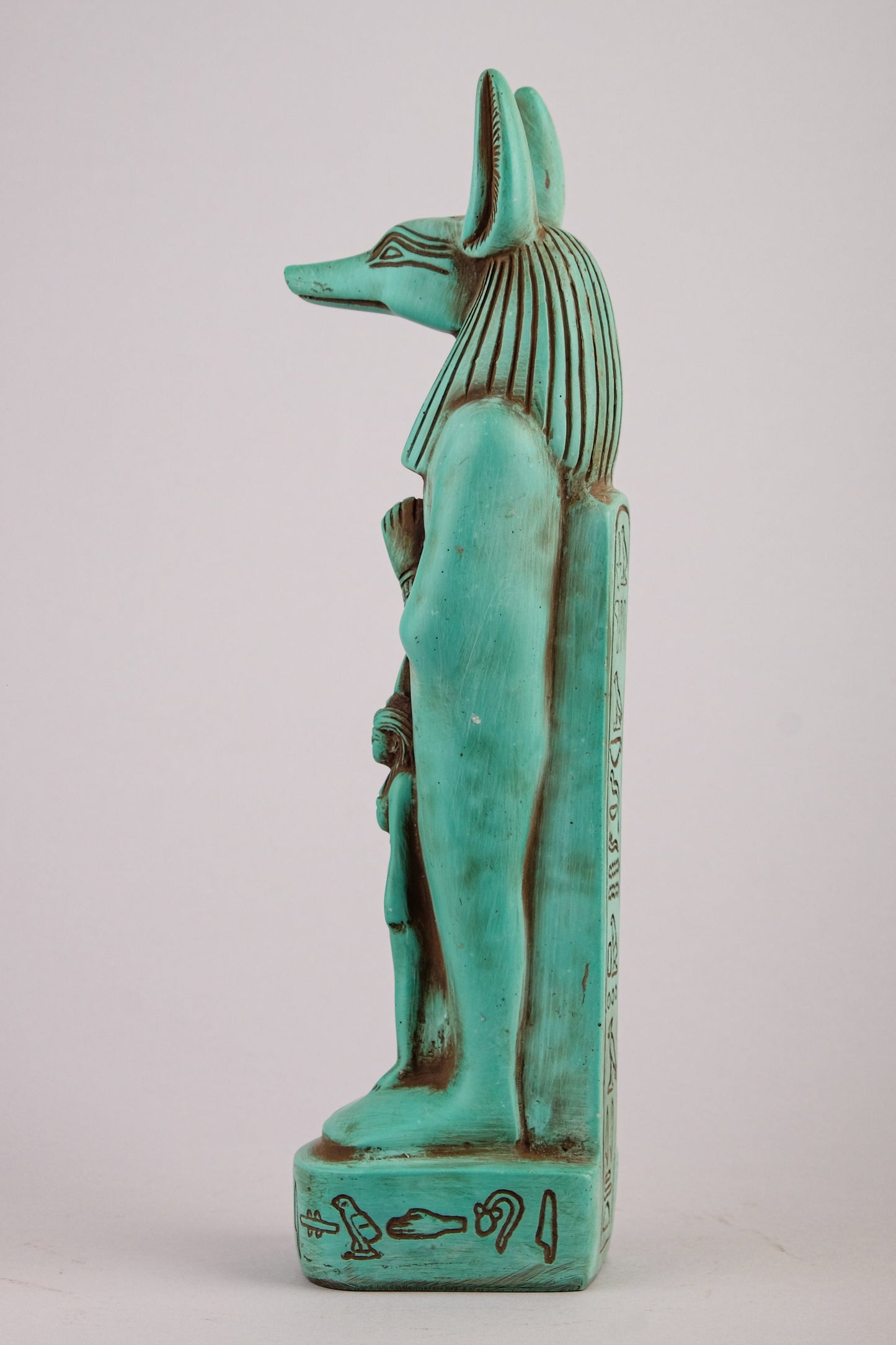 Egyptian statue of Anubis green Jackal God of afterlife and mummification standing with jackal head and human body with goddess Isis