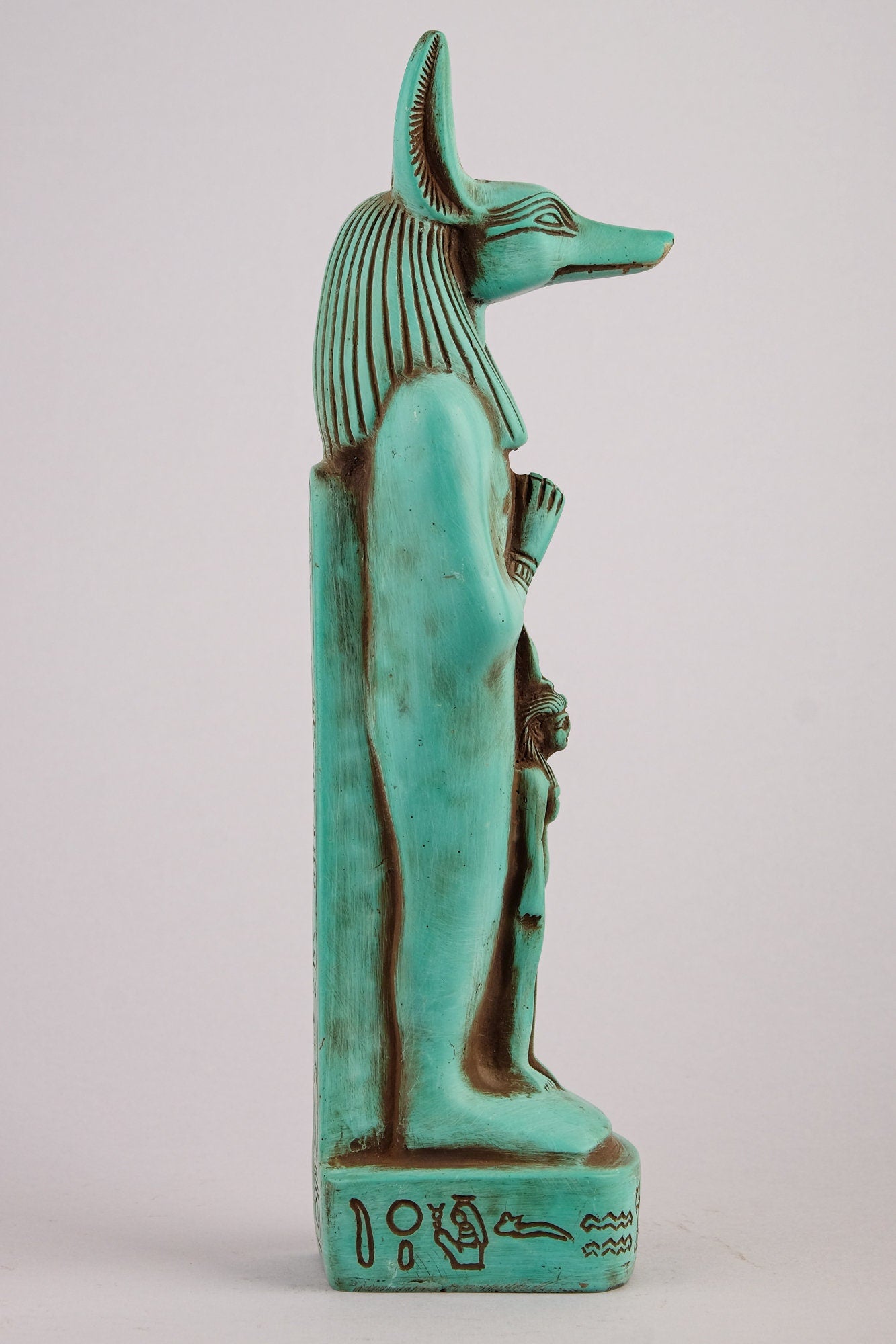 Egyptian statue of Anubis green Jackal God of afterlife and mummification standing with jackal head and human body with goddess Isis