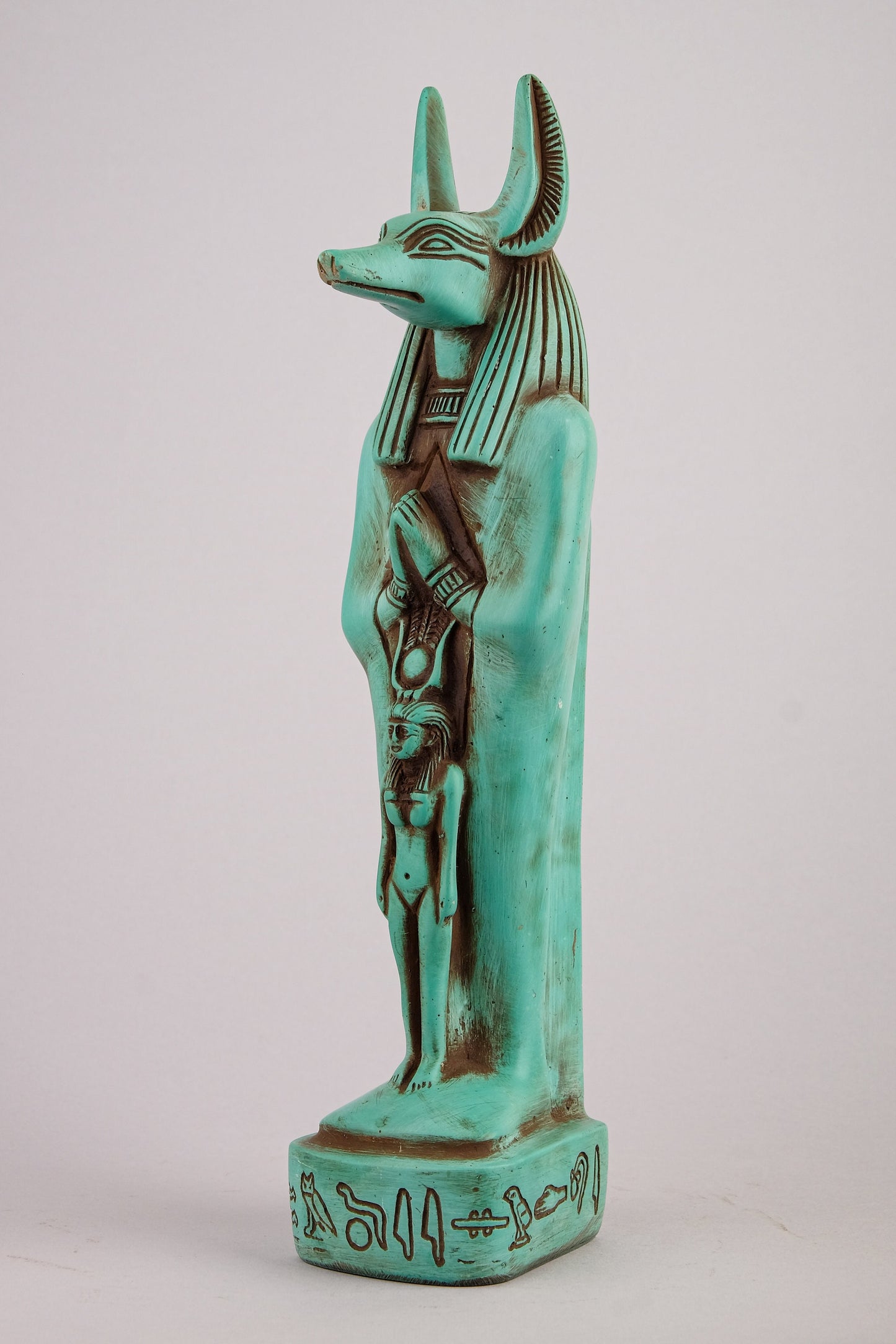 Egyptian statue of Anubis green Jackal God of afterlife and mummification standing with jackal head and human body with goddess Isis