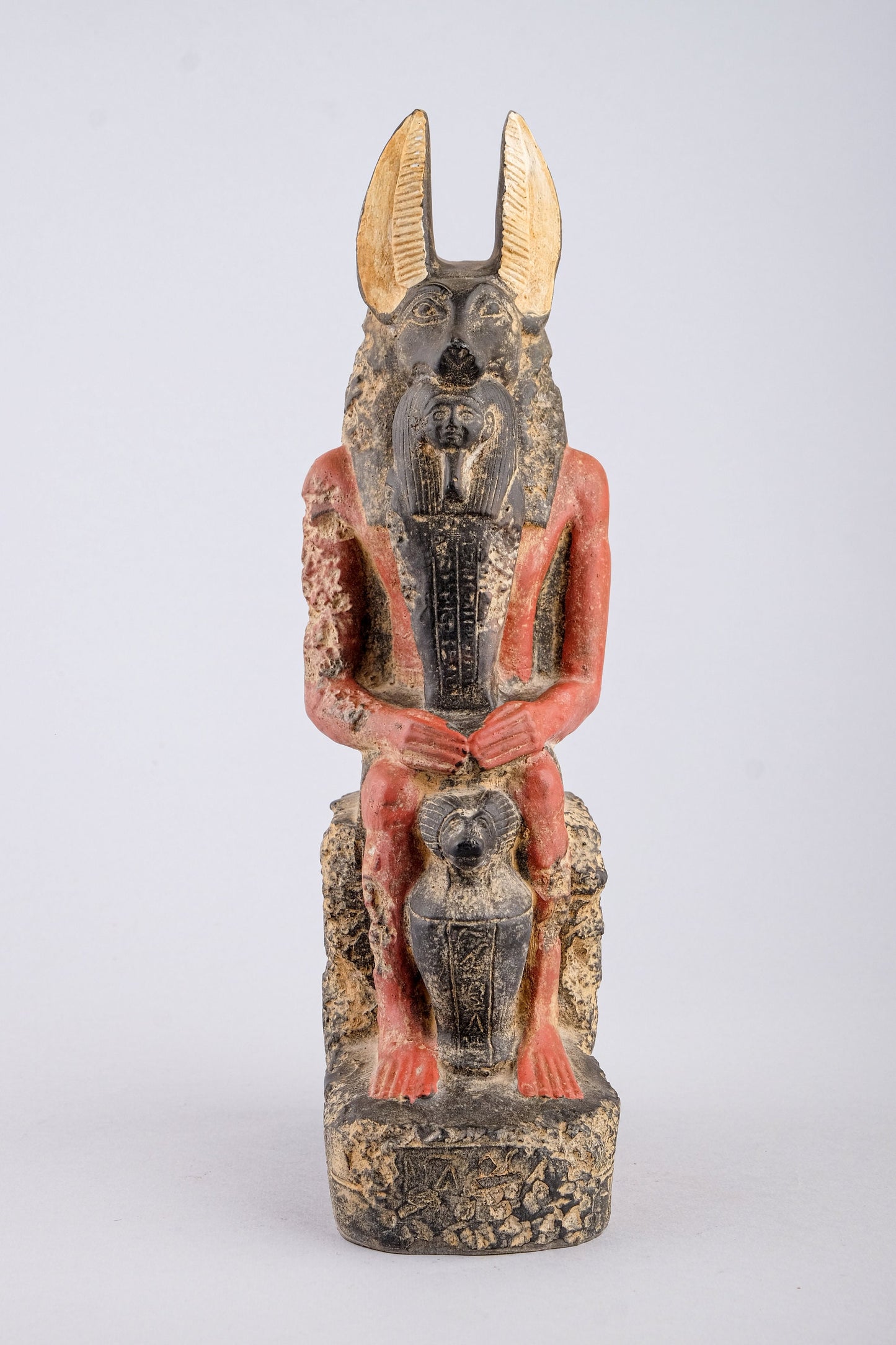 Seated Anubis Jackal holding a mummy form with a Hapi (Son of Horus) resting between his legs heavy stone handcrafted made in Egypt