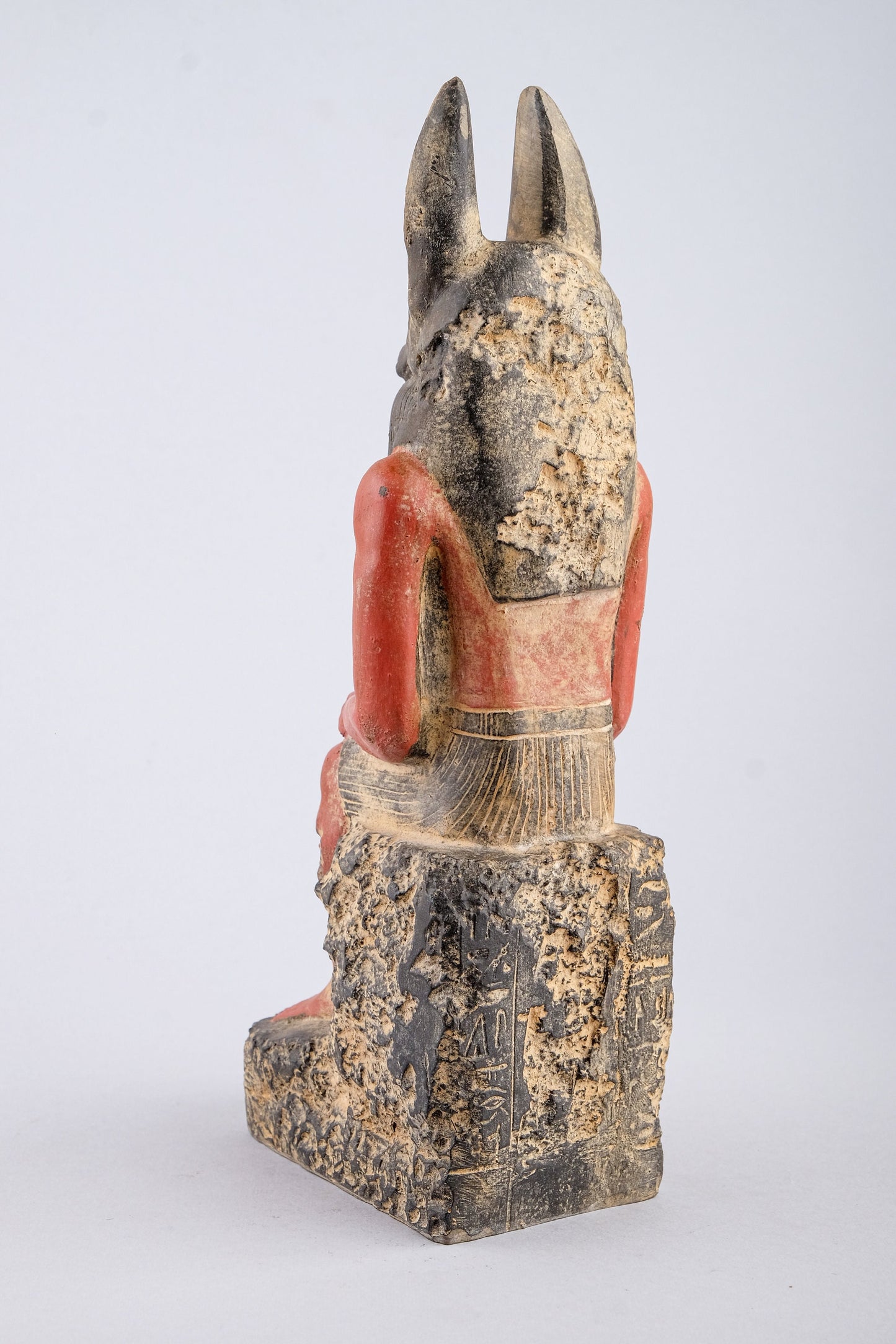 Seated Anubis Jackal holding a mummy form with a Hapi (Son of Horus) resting between his legs heavy stone handcrafted made in Egypt