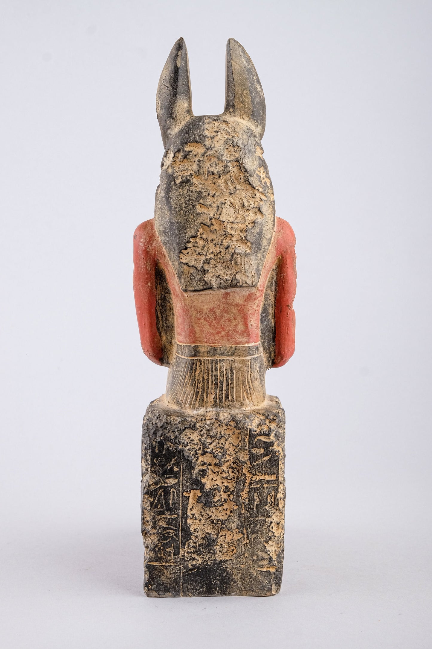 Seated Anubis Jackal holding a mummy form with a Hapi (Son of Horus) resting between his legs heavy stone handcrafted made in Egypt