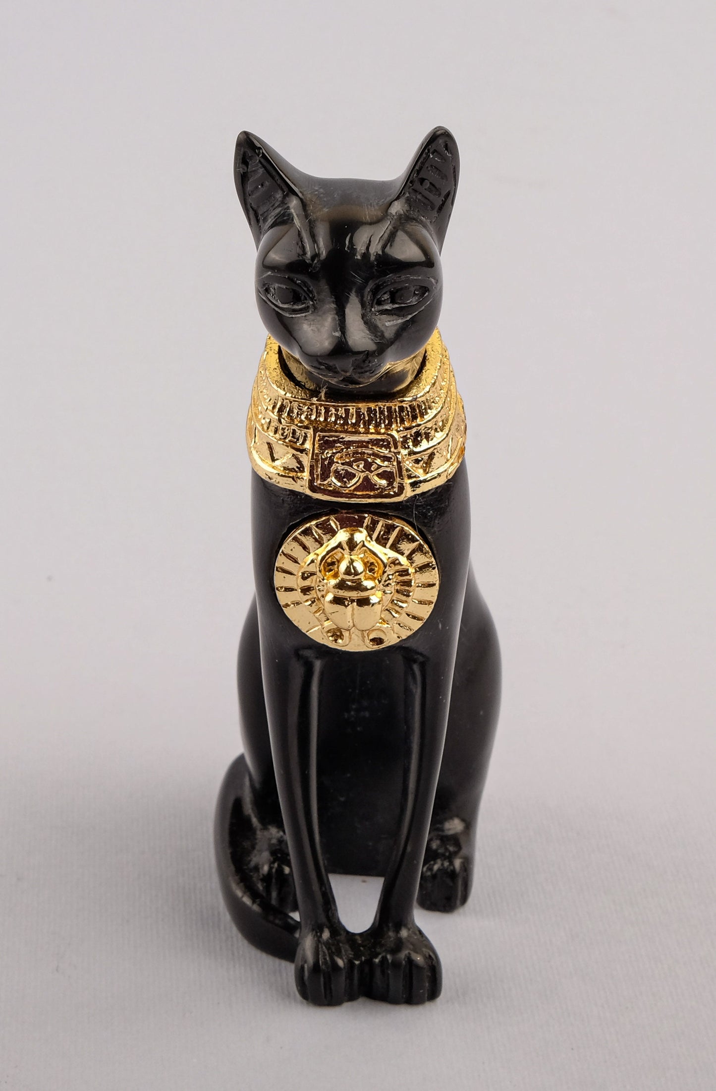 Unique ancient Egyptian statue cat Bastet Black Sculpture with front gold metal scarab, gold metal eye of Horus made in Egypt