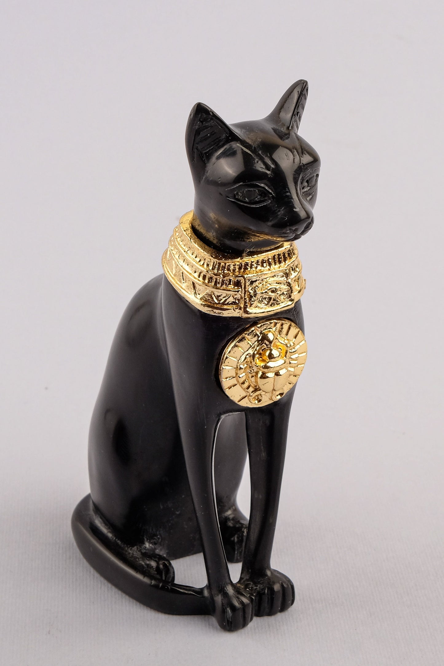 Unique ancient Egyptian statue cat Bastet Black Sculpture with front gold metal scarab, gold metal eye of Horus made in Egypt